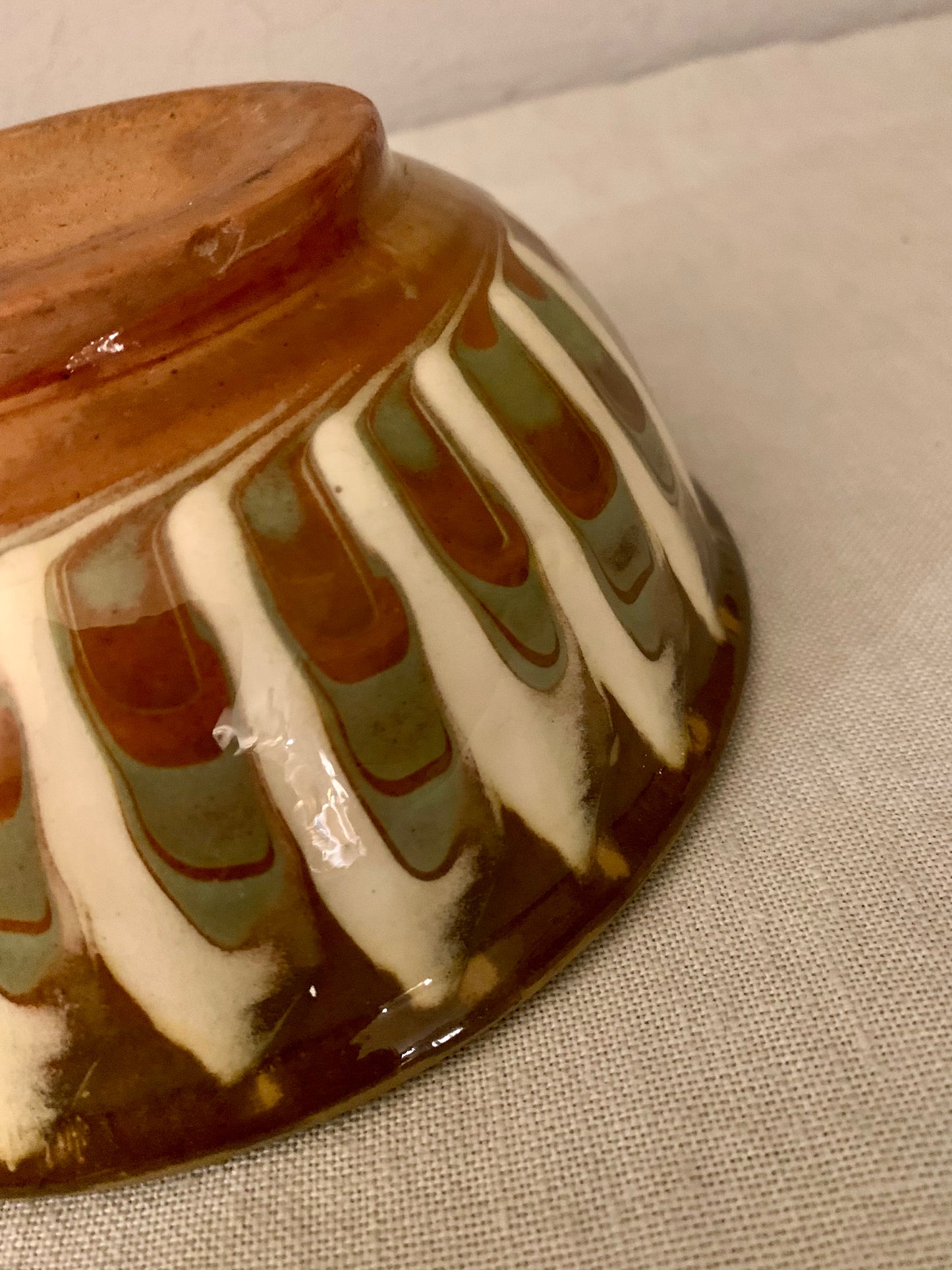 Vintage clay bowl with beautiful running glaze.