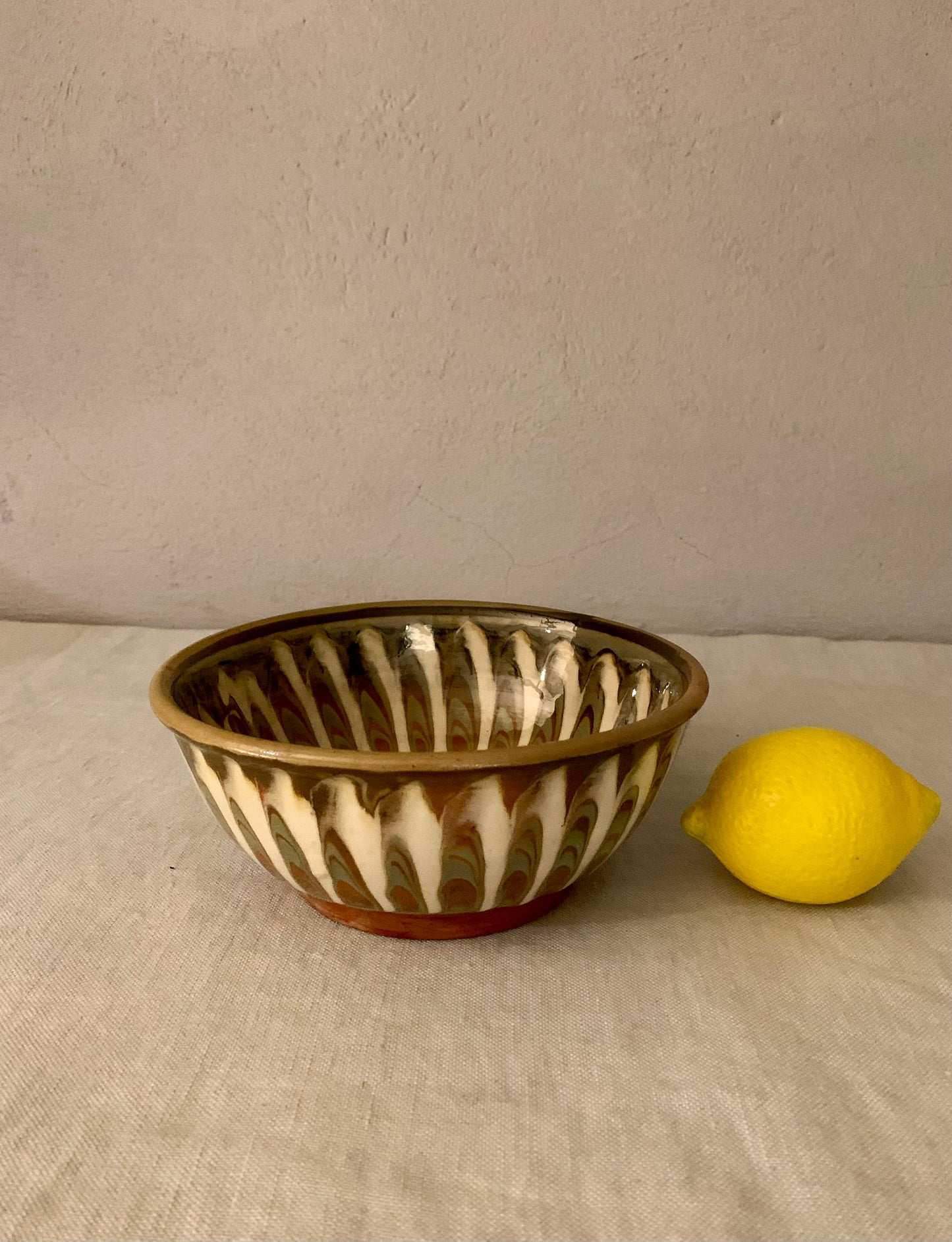 Vintage clay bowl with beautiful running glaze.