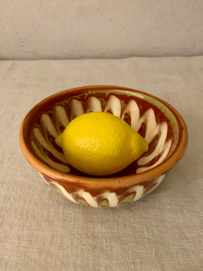 Vintage clay bowl with beautiful running glaze.