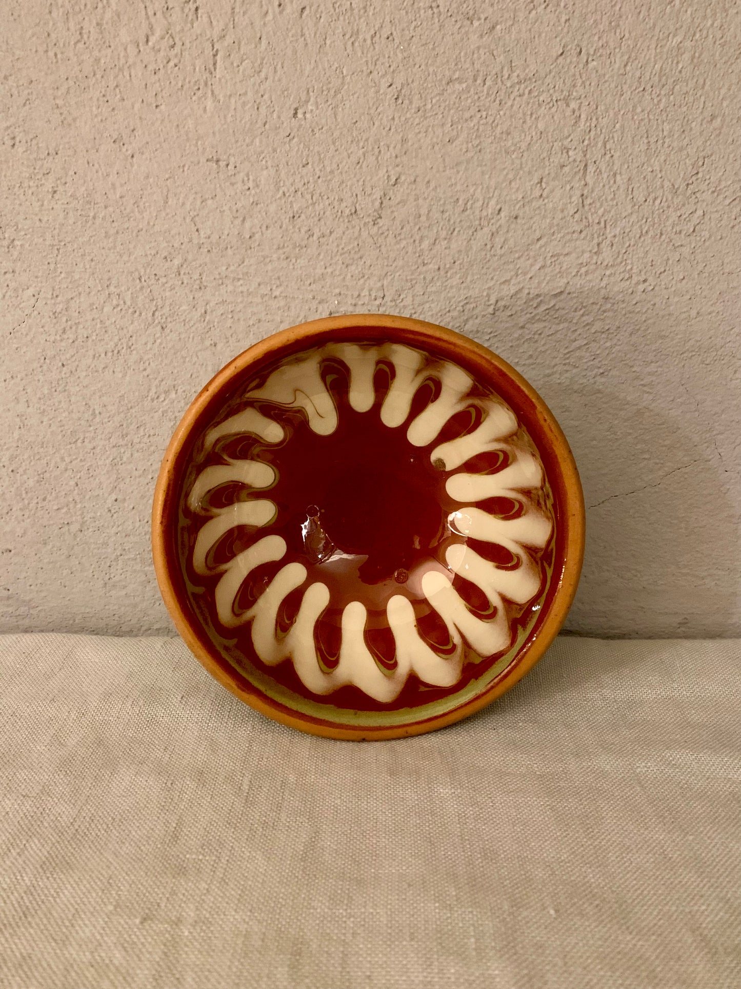 Vintage clay bowl with beautiful running glaze.