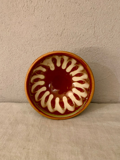 Vintage clay bowl with beautiful running glaze.