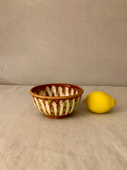 Vintage clay bowl with beautiful running glaze.