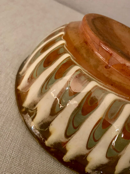 Vintage clay bowl with beautiful running glaze.