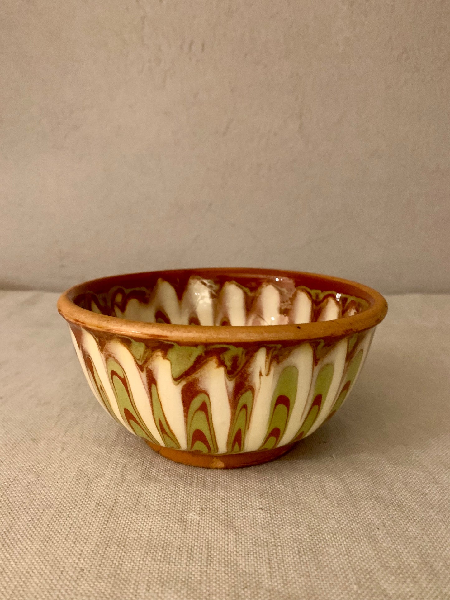 Vintage clay bowl with beautiful running glaze.