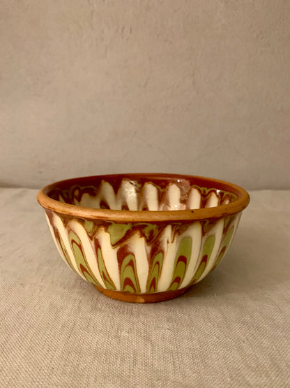 Vintage clay bowl with beautiful running glaze.