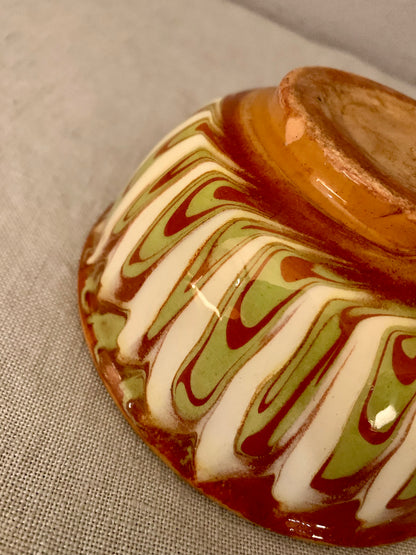 Vintage clay bowl with beautiful running glaze.
