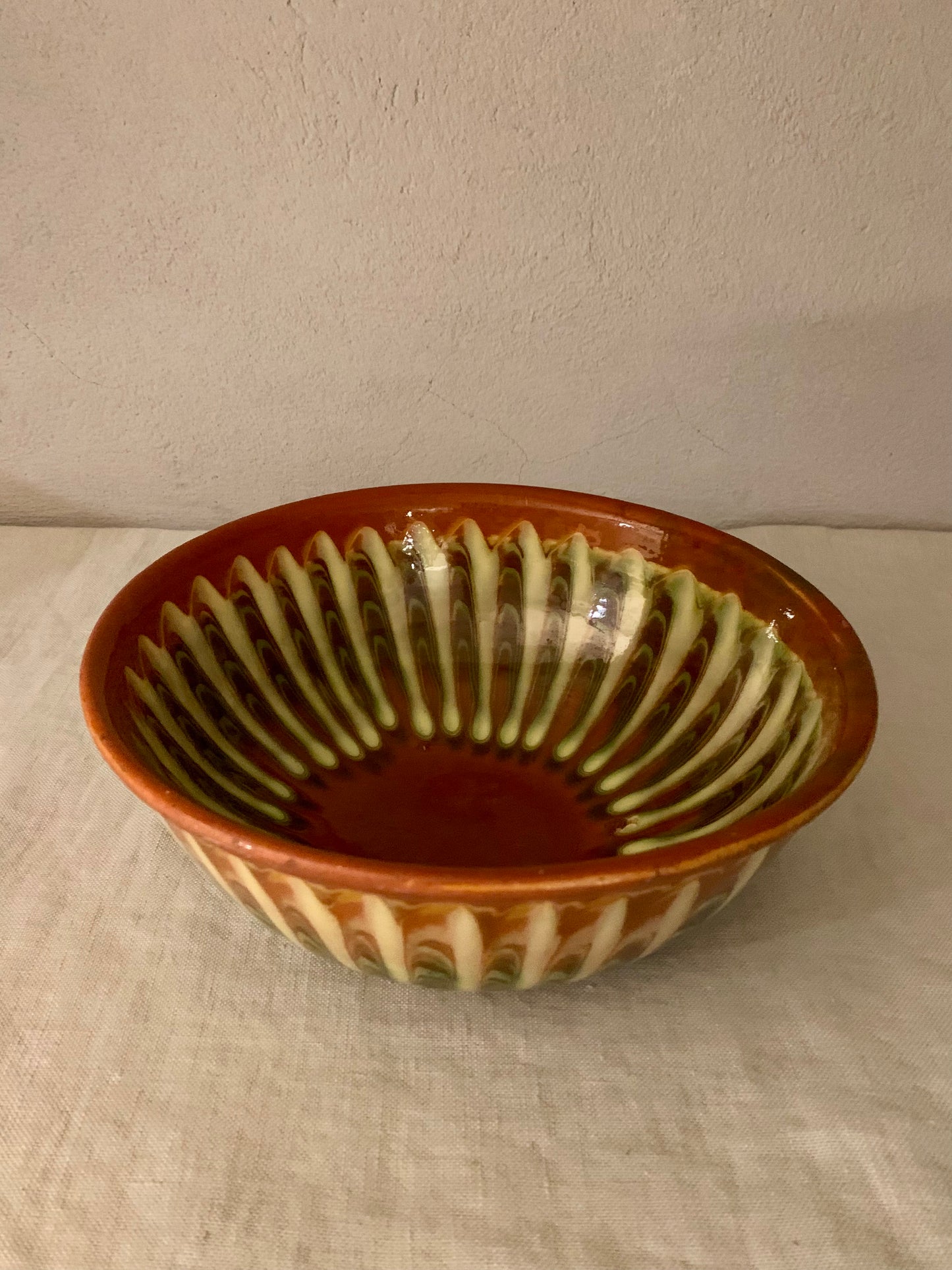 Vintage clay bowl with beautiful running glaze.