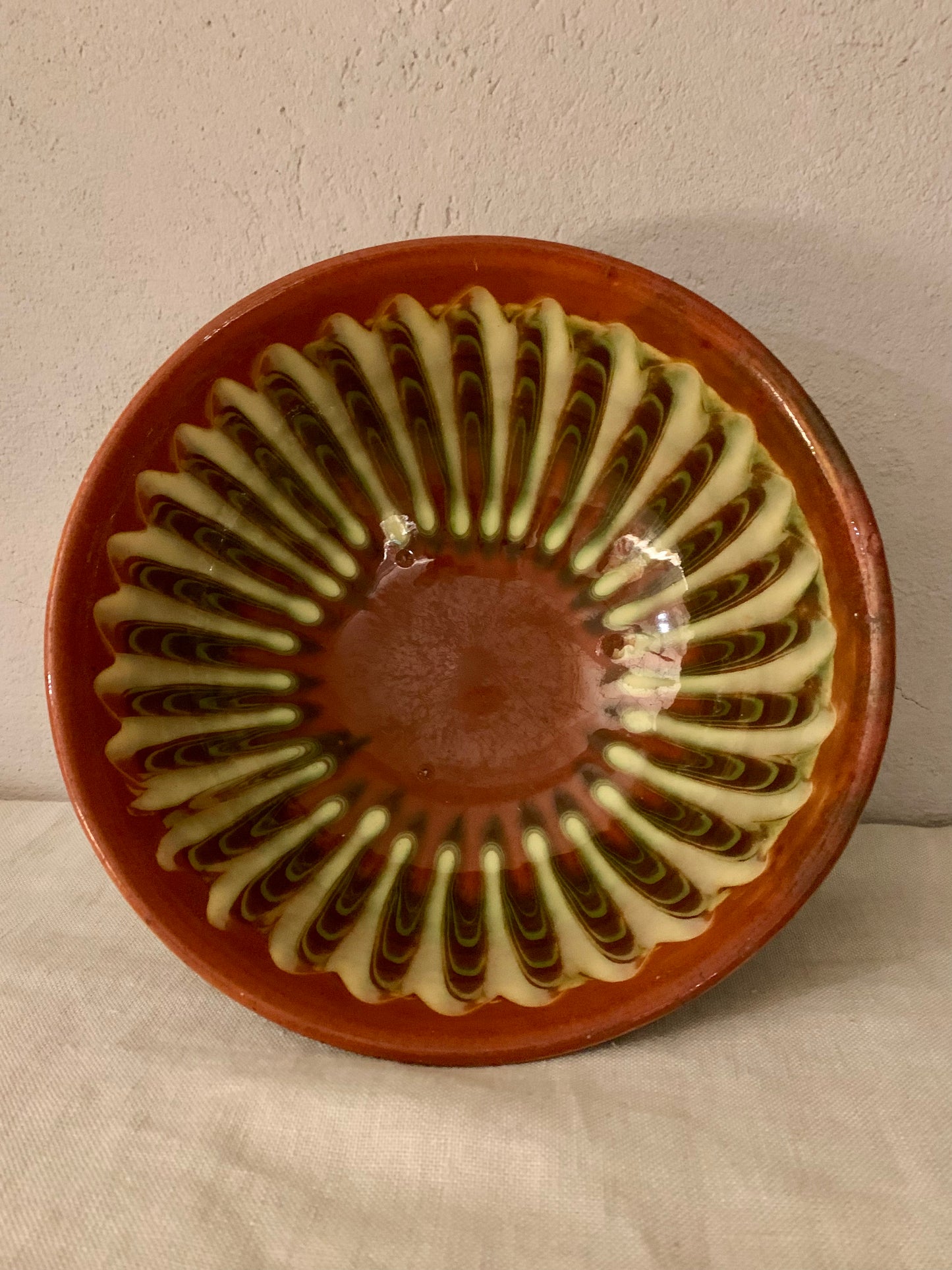 Vintage clay bowl with beautiful running glaze.