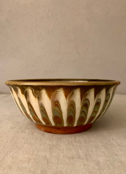 Vintage clay bowl with beautiful running glaze.
