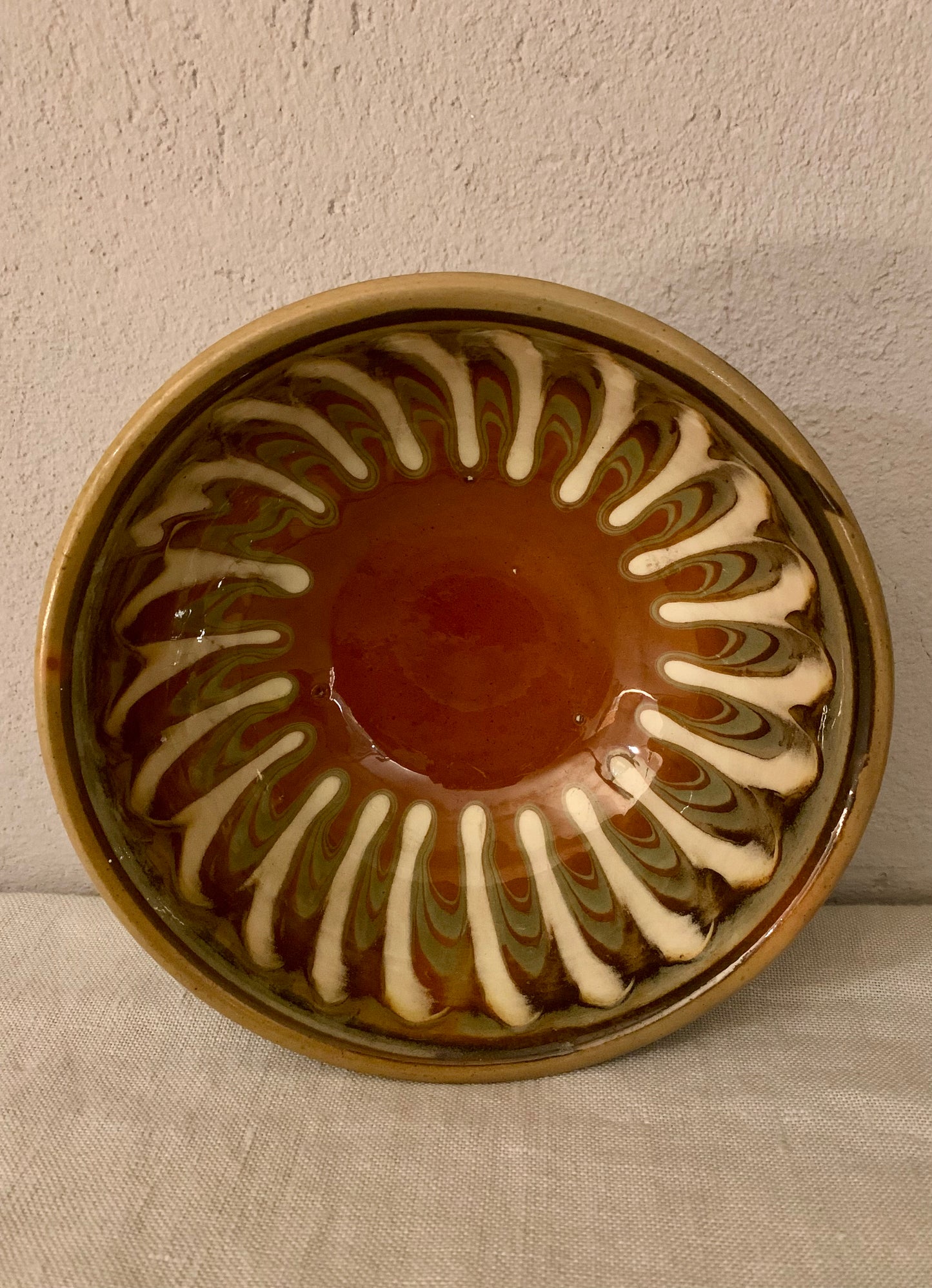 Vintage clay bowl with beautiful running glaze.
