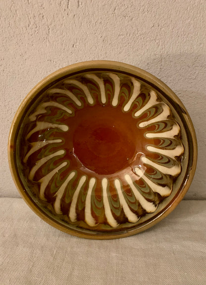 Vintage clay bowl with beautiful running glaze.