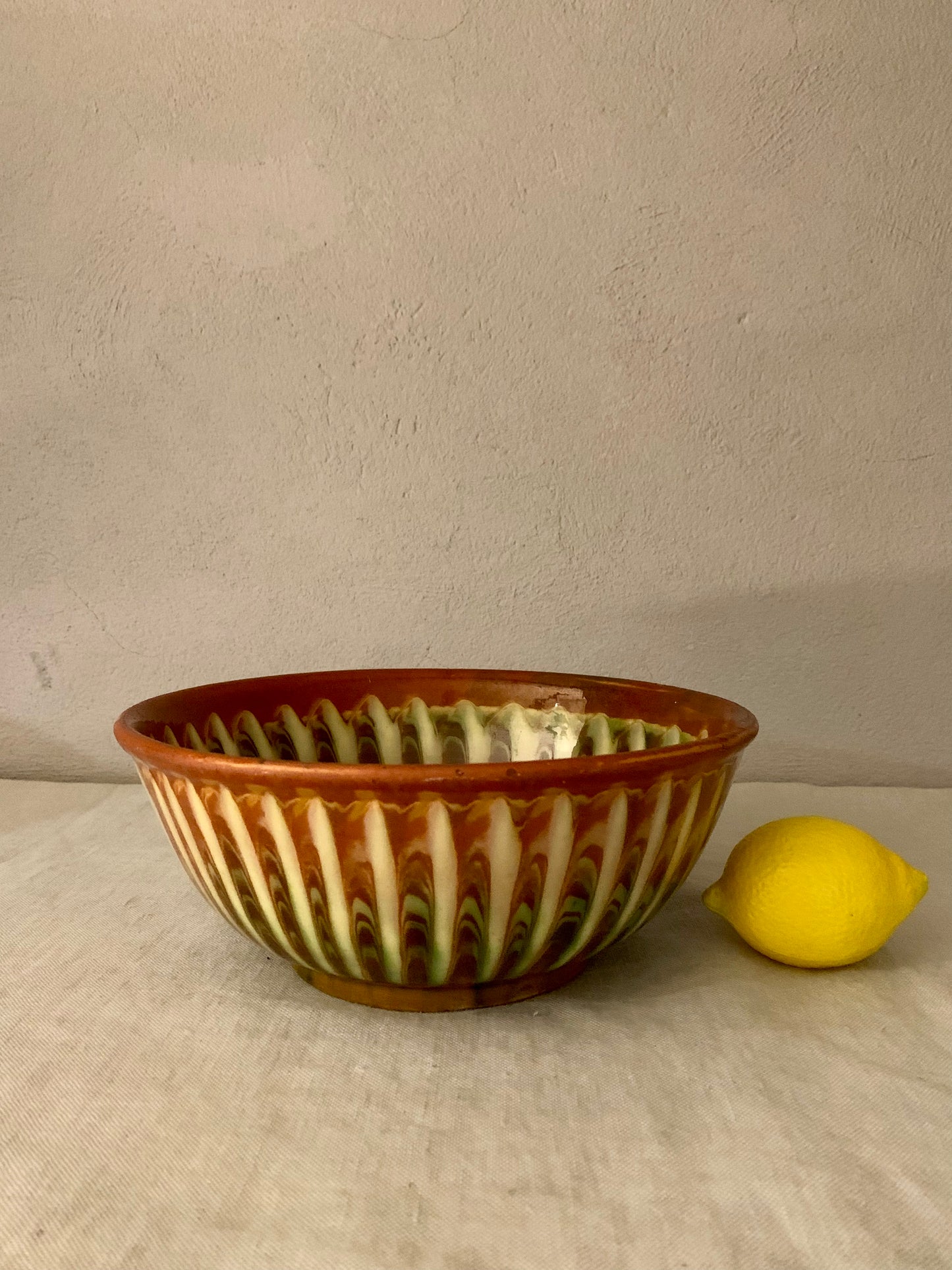Vintage clay bowl with beautiful running glaze.