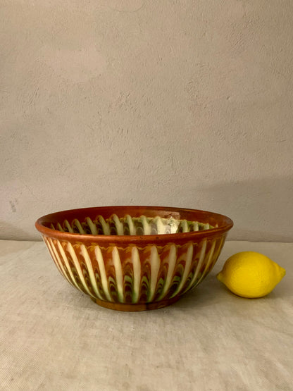 Vintage clay bowl with beautiful running glaze.