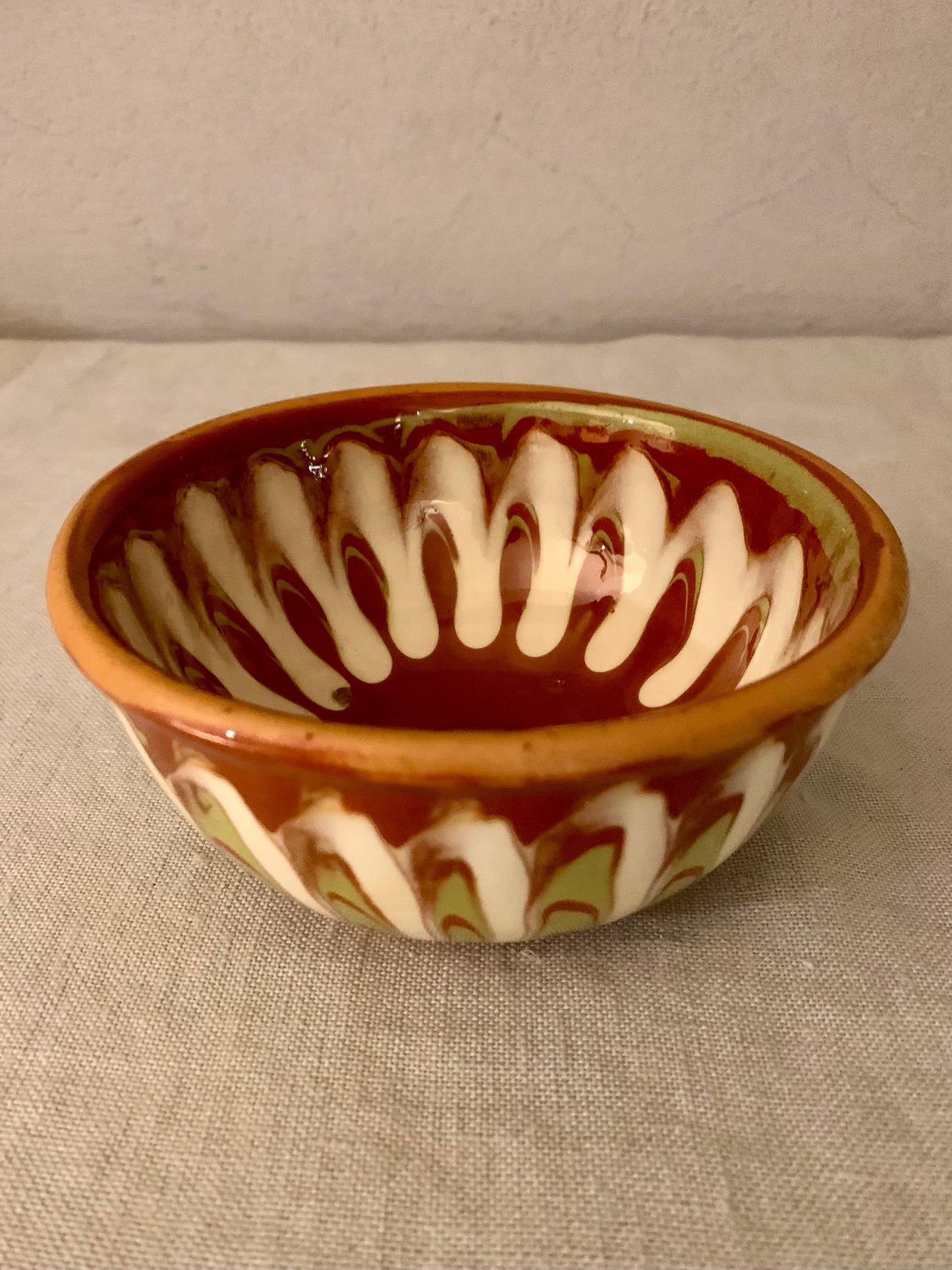 Vintage clay bowl with beautiful running glaze.