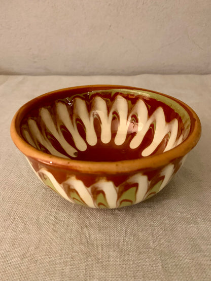 Vintage clay bowl with beautiful running glaze.