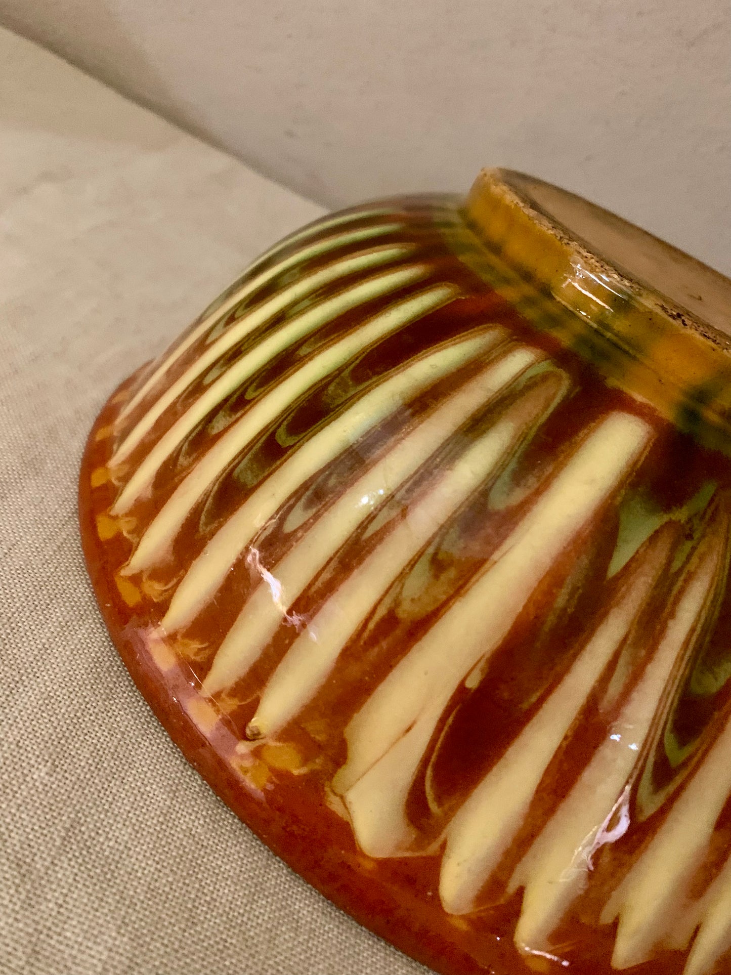 Vintage clay bowl with beautiful running glaze.