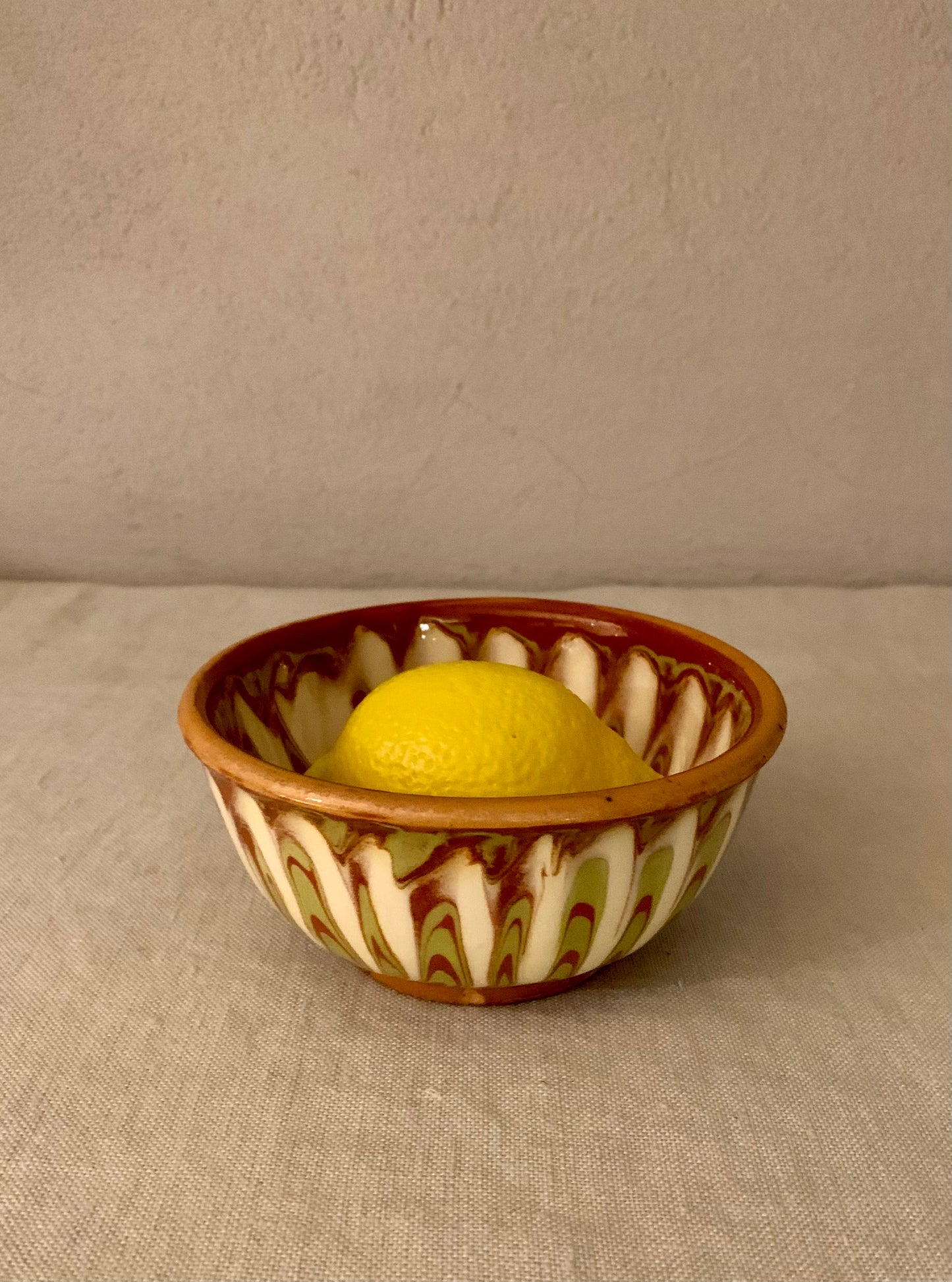 Vintage clay bowl with beautiful running glaze.