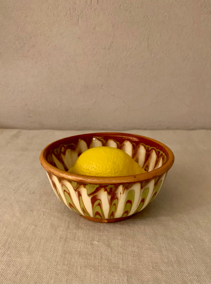 Vintage clay bowl with beautiful running glaze.